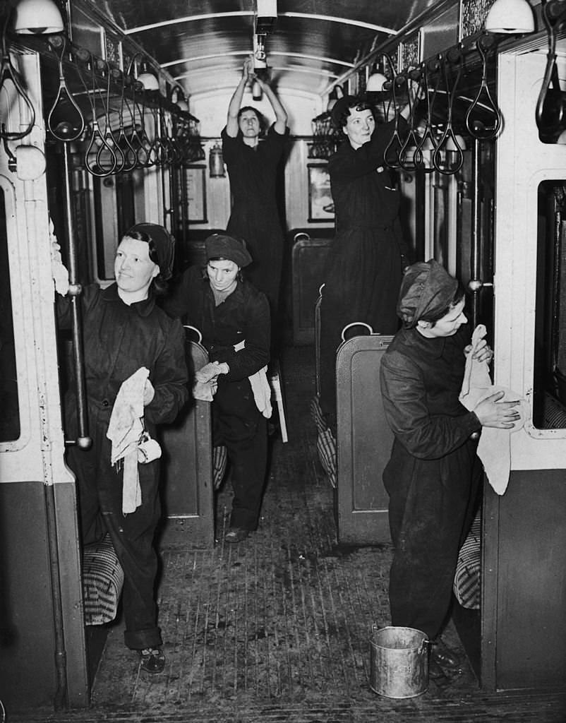Women at work cleaning the inside of a London Underground train during World War II, 20th February 1941.