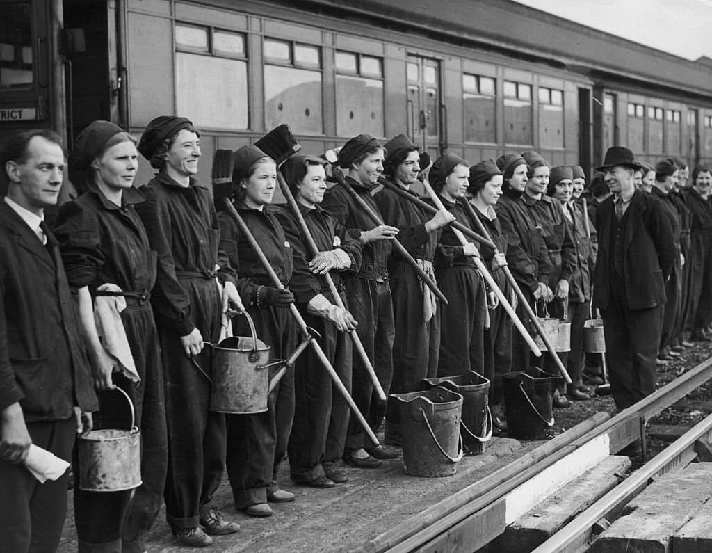 A group of women war workers on parade at a London Underground depot before starting work cleaning carriages, 17th February 1941.