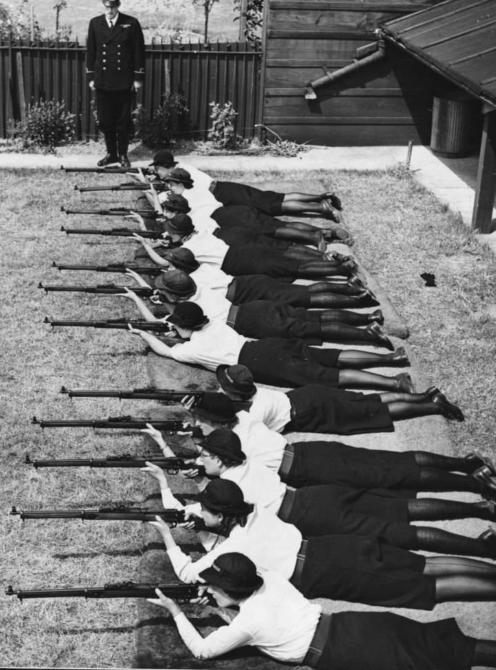 Members of the Women's Royal Naval Service, nicknamed Wrens, train in marksmanship at a rifle range during WWII.