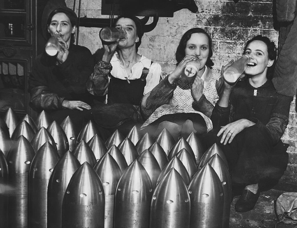 Women workers in a munitions factory drinking milk during their break, 1941.