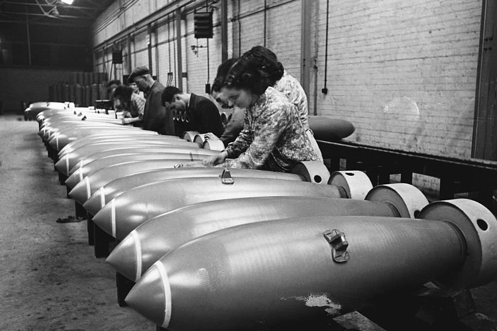 Munition workers at a RAF munition factory fit the components to bombs.
