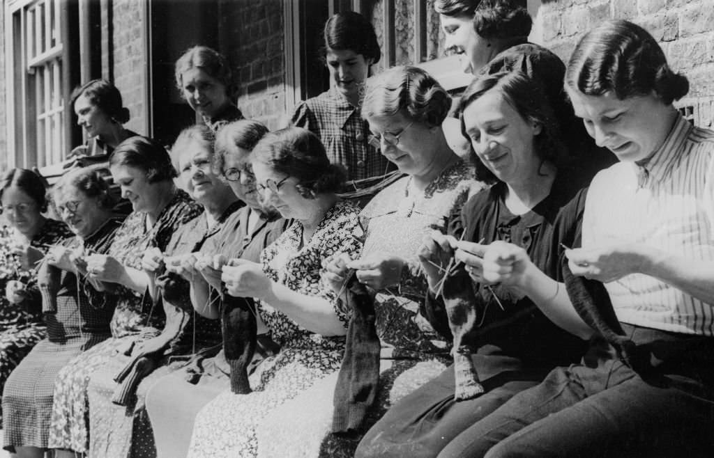 Women from the Duchy of Cornwall Estate in South London knit socks with wool bought from the proceeds of their children's salvage efforts.