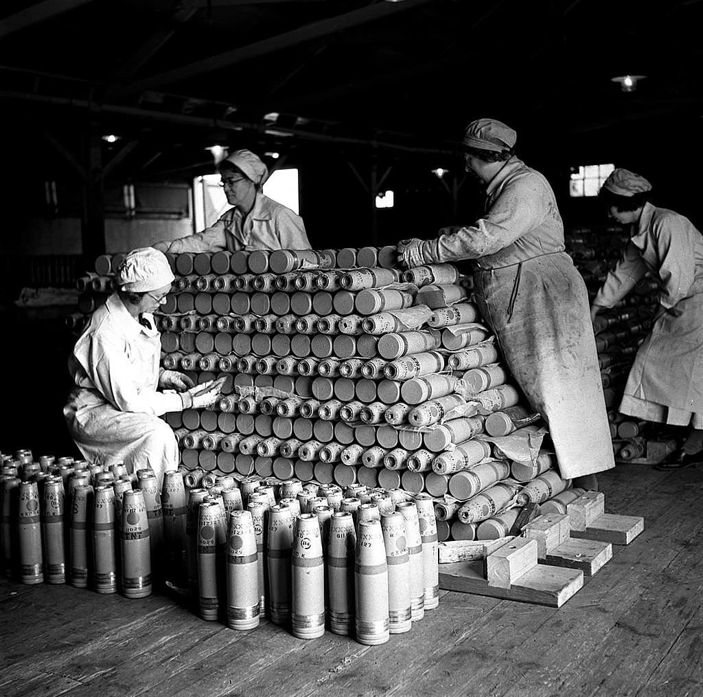 Women workers stack ammunition shells at a factory in Woolwich, London, 1940