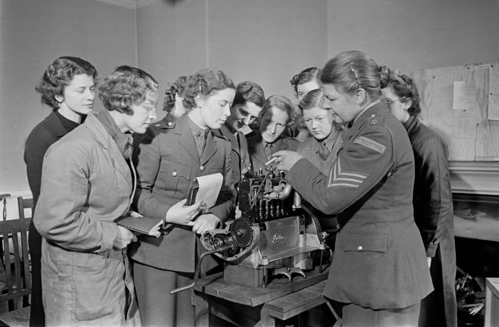 British Army's Women's Transport Service (FANY) being instructed in the working of an internal combustion engine during a mechanics class by a section leader at an army establishment in England in January 1940.