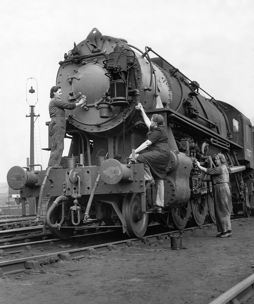 An American locomotive, one of the first batch to arrive in the United Kingdom for many years, being cleaned by women.