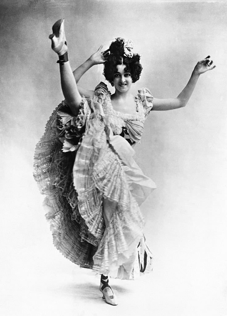 The cancan dancer Saharet kicks her leg into the air, 1900s