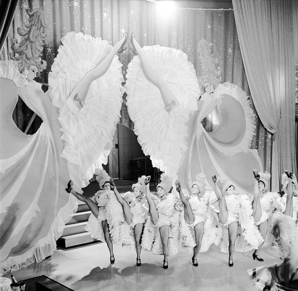 Dancers from Miss May's troupe perform French Cancan on a barge during the river festival at Bassin de la Villette, 1955