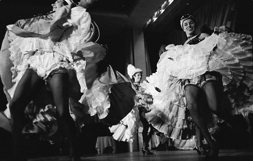 Can-Can girl Regine performing with the rest of the troupe at the Moulin Rouge in Paris, 1955.