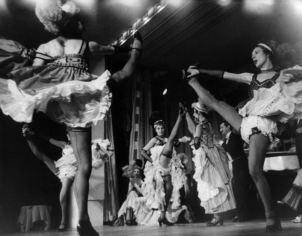 Can-Can dancer Regine performing on stage at the Moulin Rouge theatre in Paris, 1955.