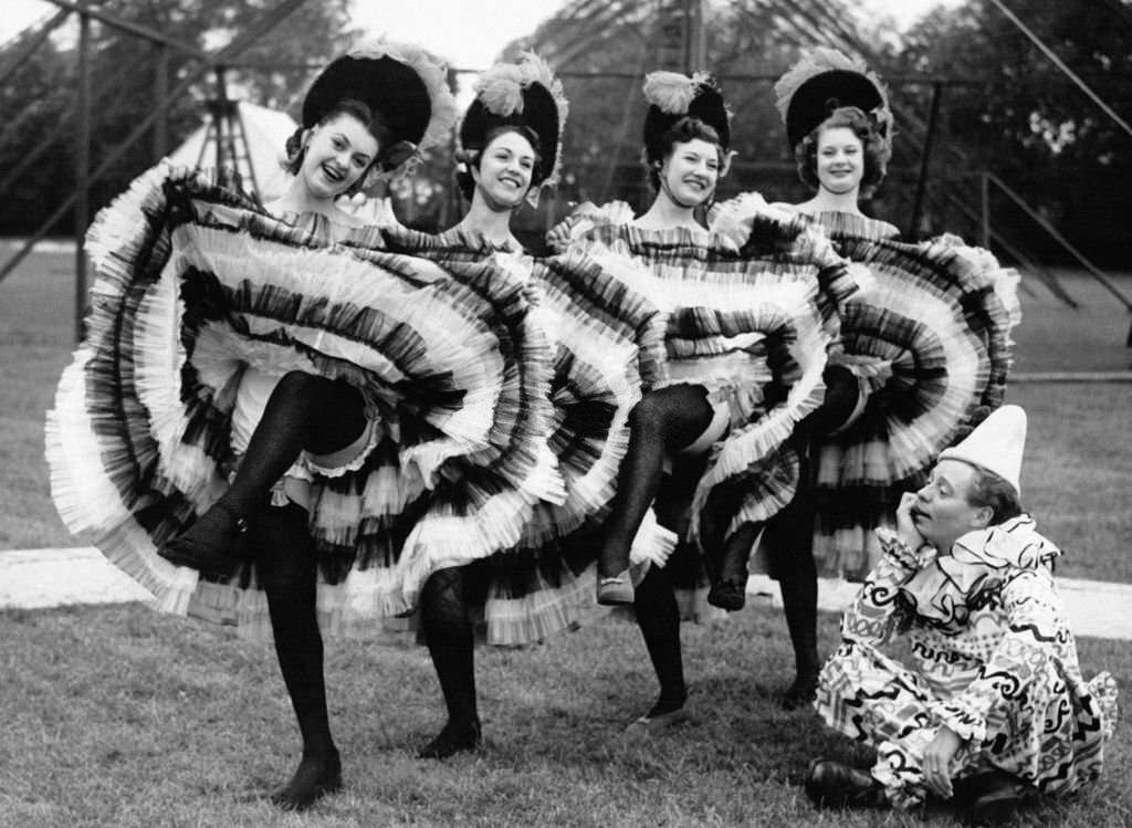 Jimmy Handley watches French cancan dancers rehearsing for the Roehampton Theater and Film Festival, 1950