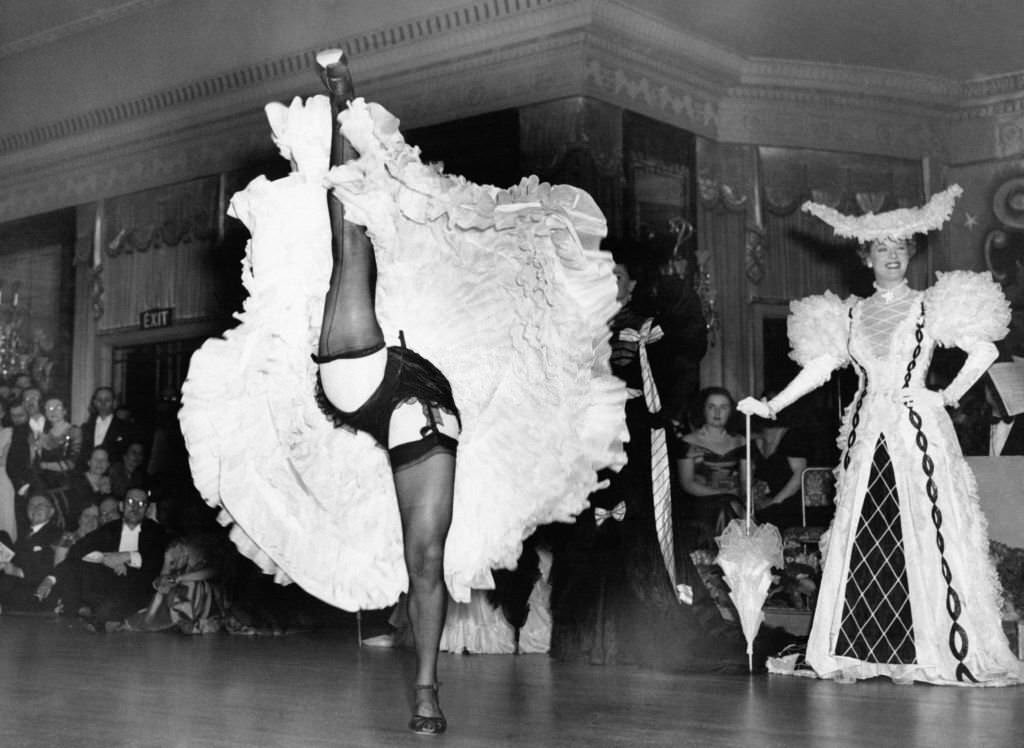 A dancer performs a cancan during the National Advertising Benevolent Fund Ball at the Dorchester Hotel on May 3, 1949