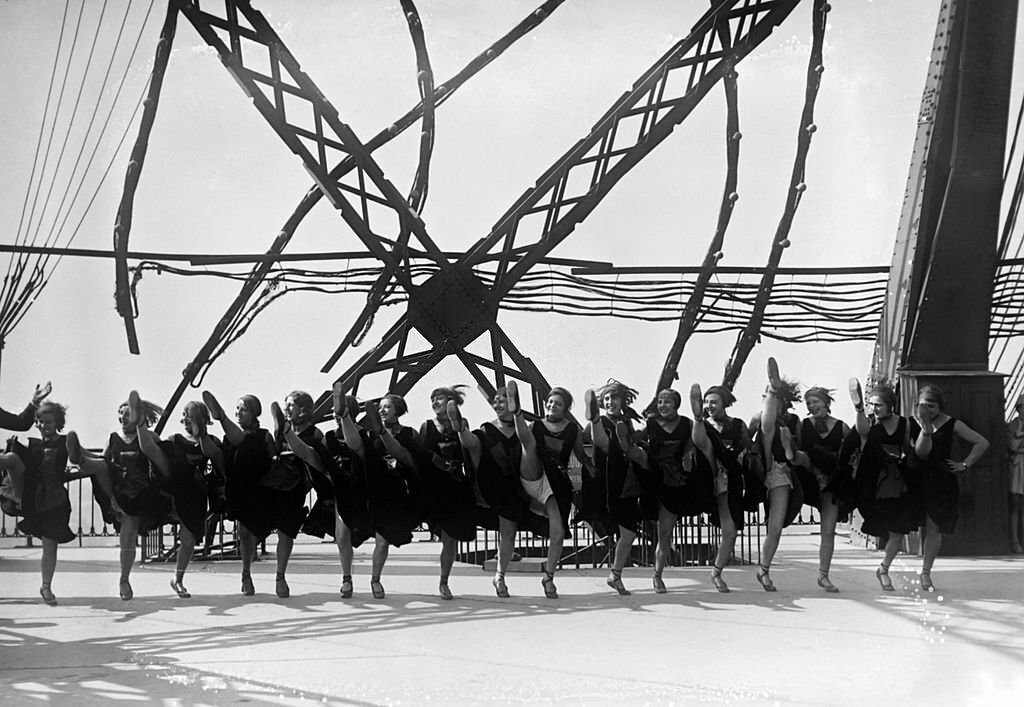 Dancers of famous cabaret 'Moulin Rouge' at the Eiffel Tower in September 1929 in Paris, France.