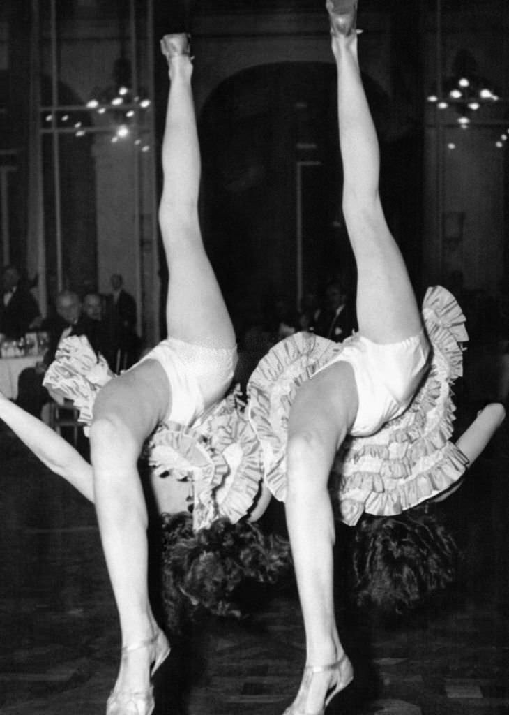 Two cancan dancers are the attraction of a dinner offered by the Anglo-American press at the Claridge Hotel, 1906