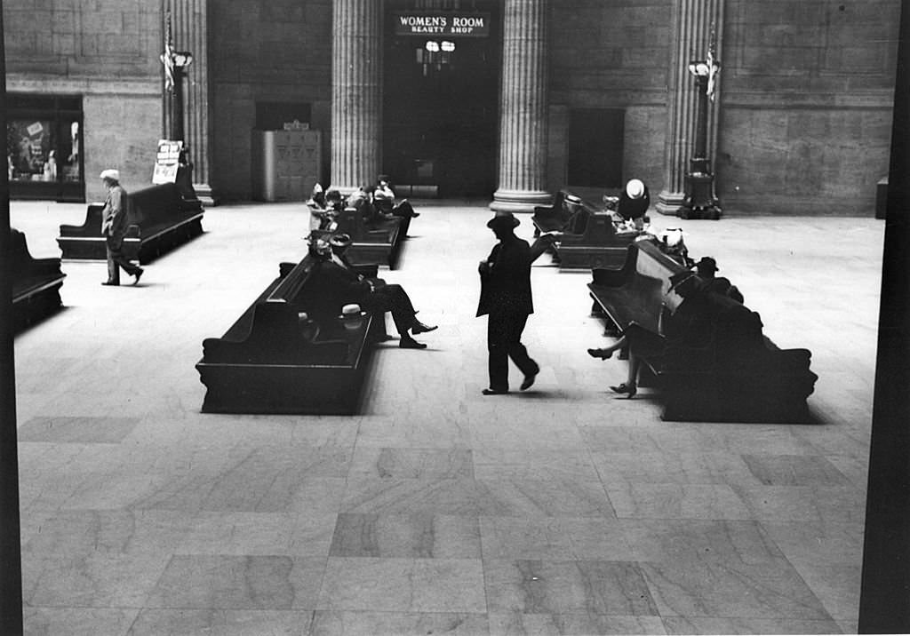 Passengers wait at the nearly deserted railway terminal at Union Station, Chicago, Illinois, July 1941.