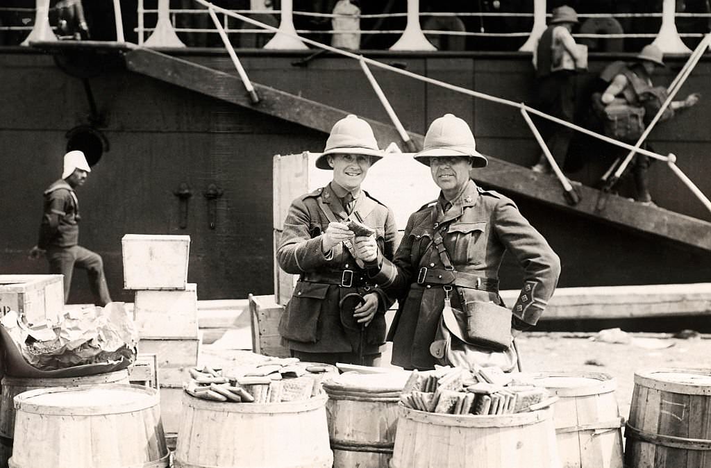 Wedgwood Benn MP (left) tasting the biscuits that were supplied to the troops for that day's rations on landing at Alexandria during World War One, 1915.