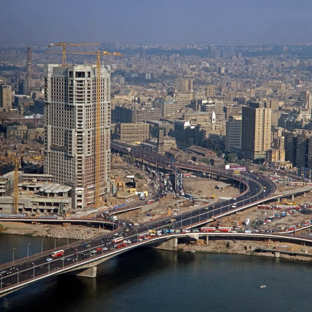 Ramses Hilton Hotel under construction and "6 October" bridge at Cairo, Egypt, late 1970s.