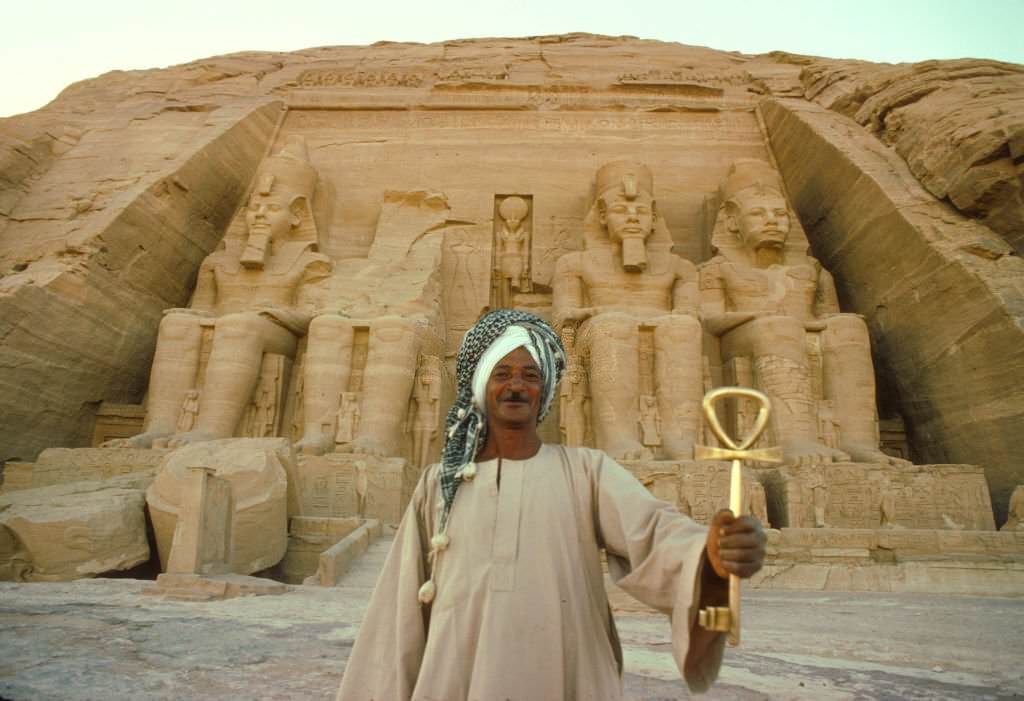 Egyptian man holding the Pharonic symbol, called the Ankh. Egypt, Abu Simbel, 1977.