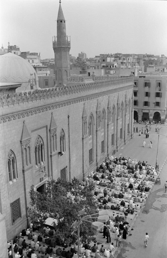 People praying in front of a mosque on a street in Cairo in October 1978