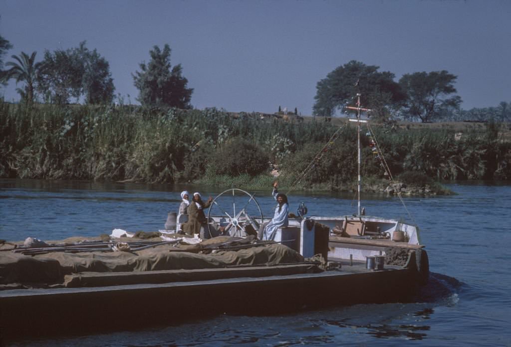 Men transporting goods on their boat on the Nile river.