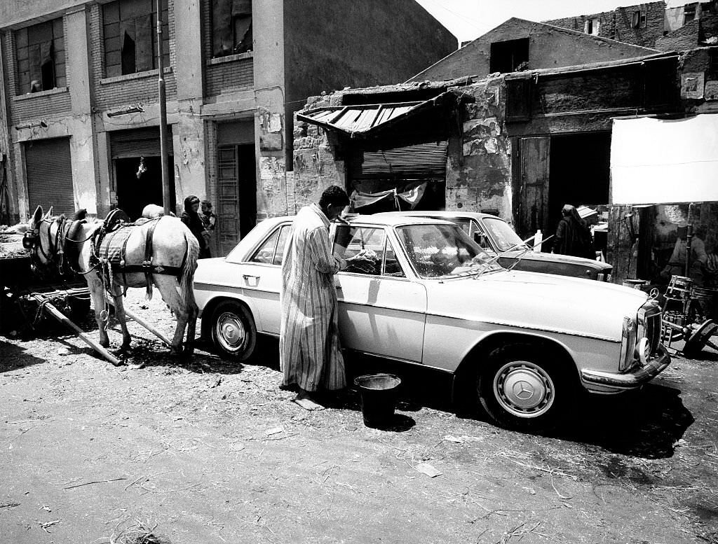 Man cleaning his car in Cairo, 1976