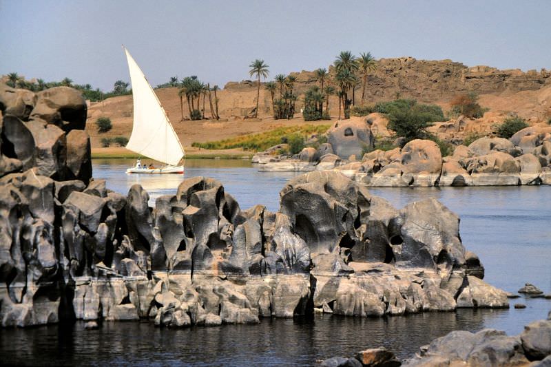Felucca sailboat amid weathered rocks, Aswan, Egypt