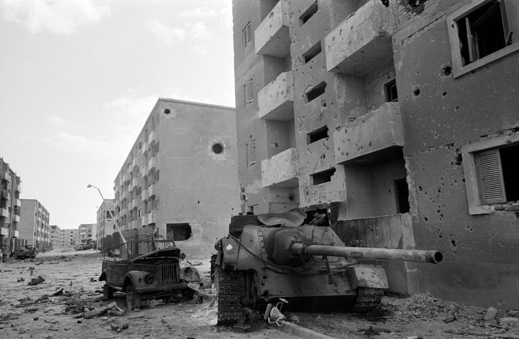 Destroyed Egyptian military vehicles in a deserted Suez street, 1973