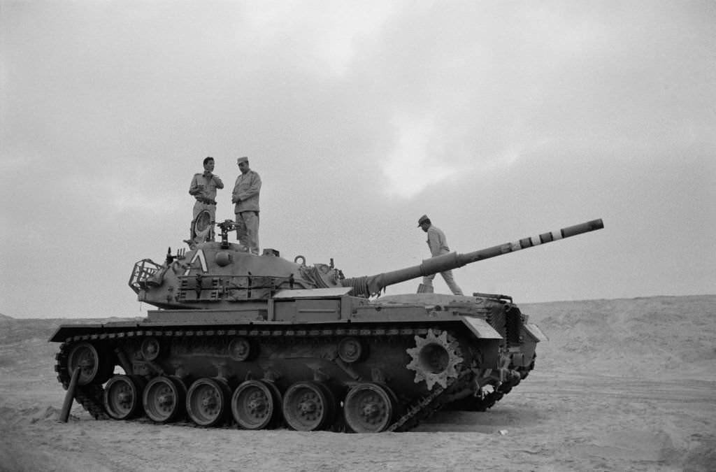 Egyptian soldiers on a tank captured from the Israeli army near the front at the Suez Canal during the Yom Kippur War in October 1973