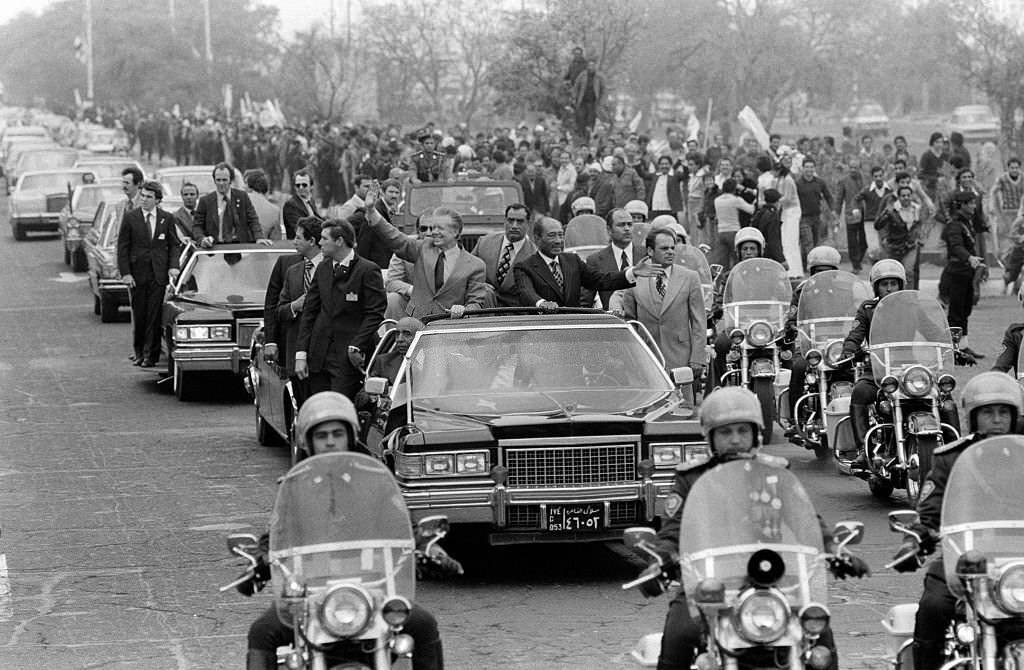 Jimmy Carter and Anwar Sadat wave to the crowd during the US President's visit to Cairo, 1979