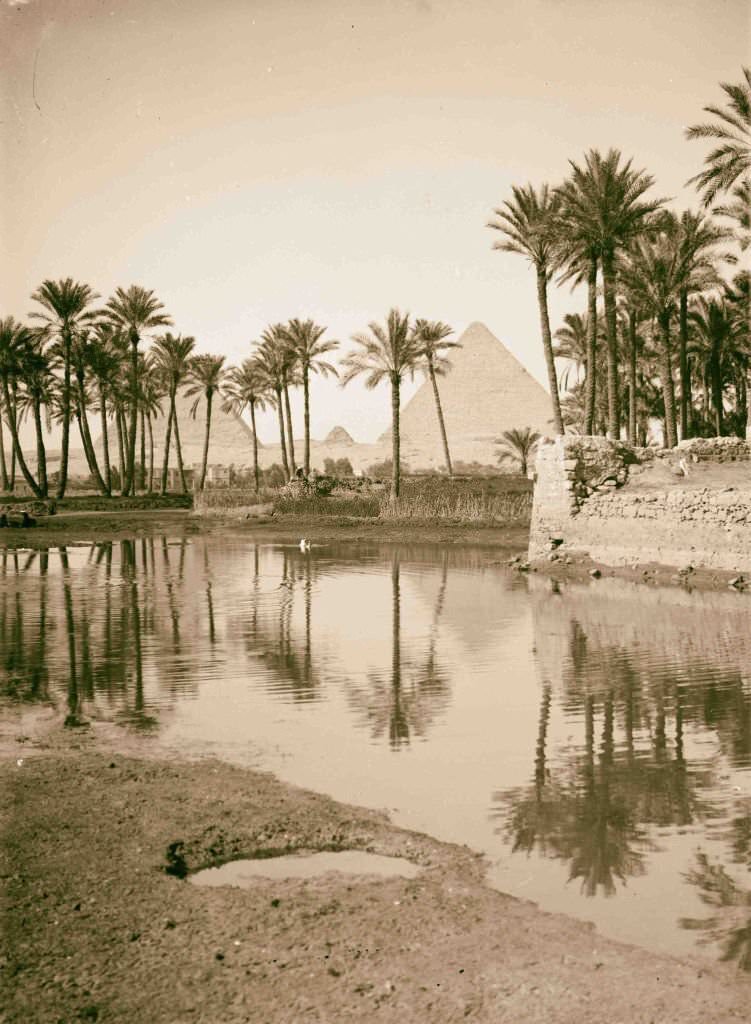 View of Pyramids with native village in foreground, Egypt, 1900.