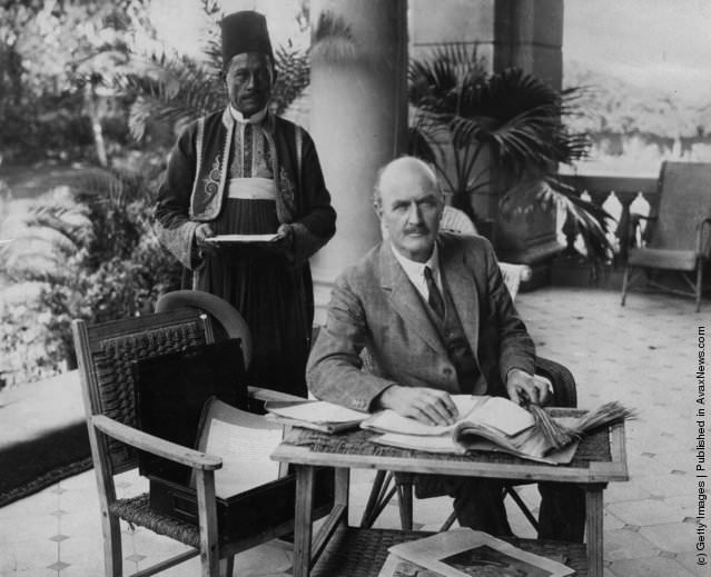 English soldier Edmund Henry Hynman Allenby, 1st Viscount Allenby, at work on the verandah of the Residency at Cairo with his Egyptian servant.