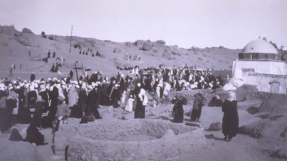A large group of Egyptian people gather together for the Feast of Bairam near the city of Aswan, 1900