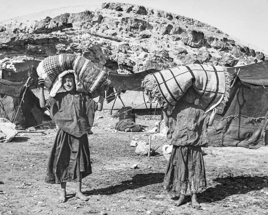 Victorian/Edwardian.Social History. An expidition in Cairo boys carrying their beds from base camp, 1900s