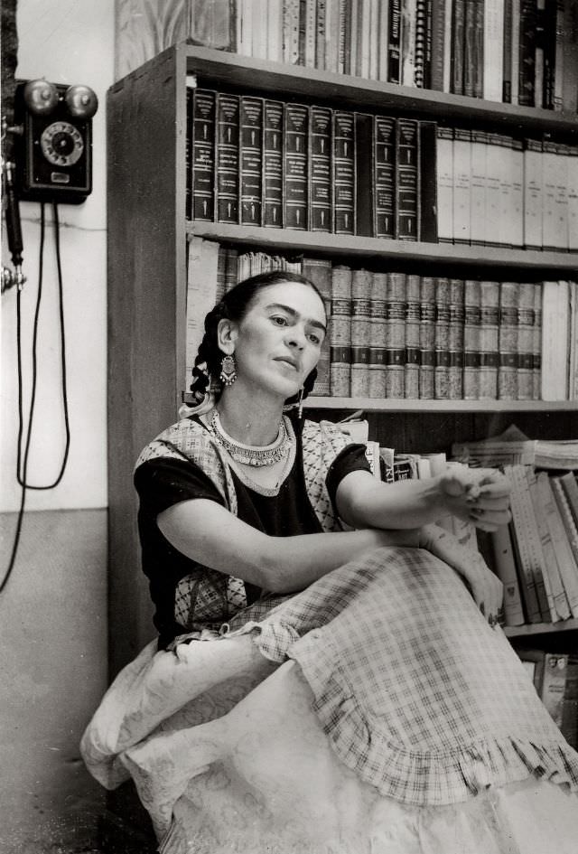 Frida Kahlo in the Library of the Blue House, 1949.