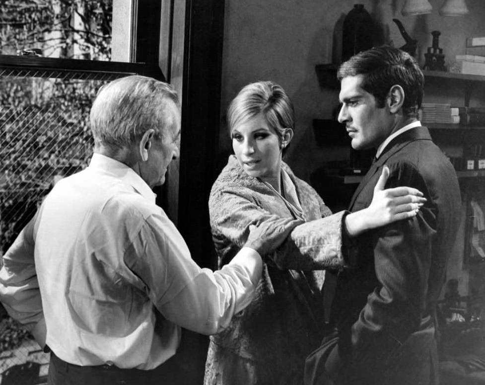 Director William Wyler rehearses scene with Barbra Streisand and Omar Sharif on the set of the film 'Funny Girl', 1968.
