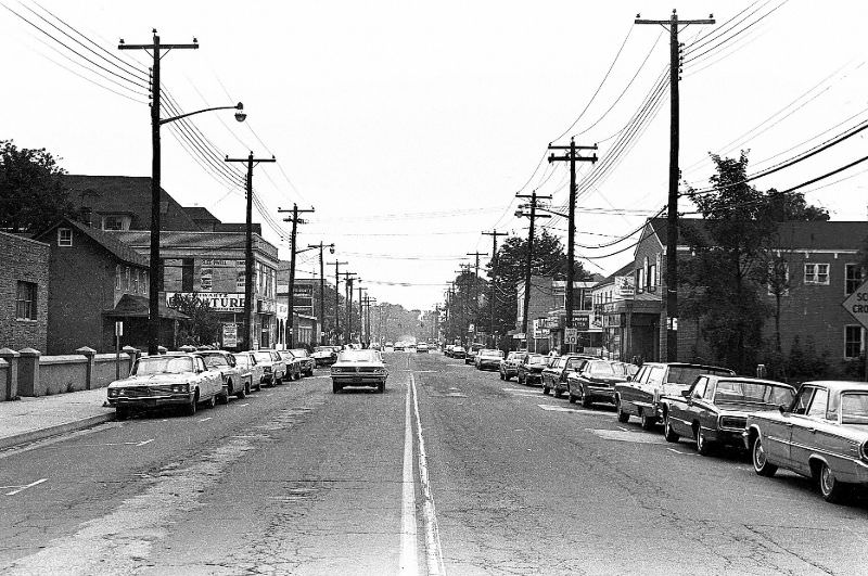 Broadway looking south from middle of block between Nicholai St. and Cherry St. St. Ignatius to the left. Dwyer's tavern on the right, Hicksville, New York, 1967