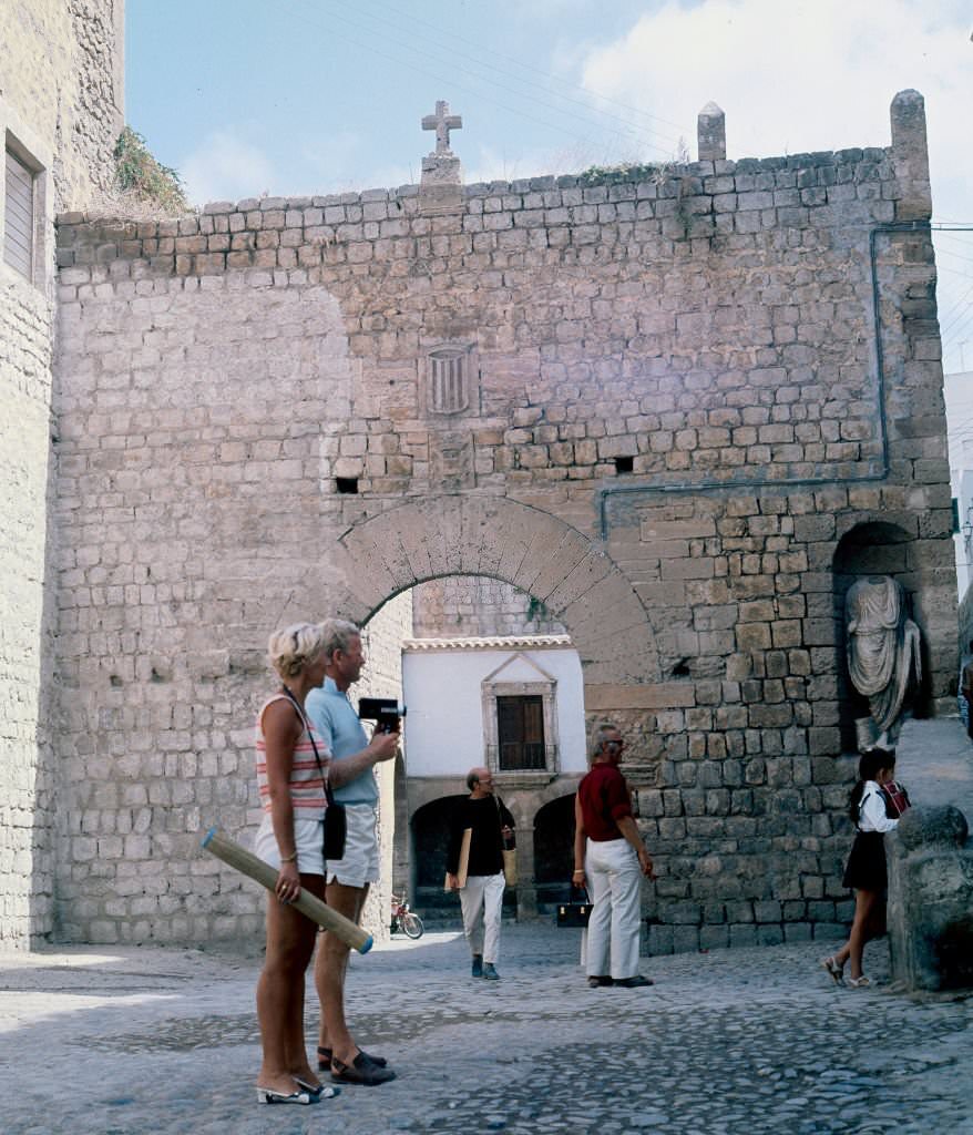 Tourists in ancient walls of Ibiza, Balearic Islands, Spain, 1975.