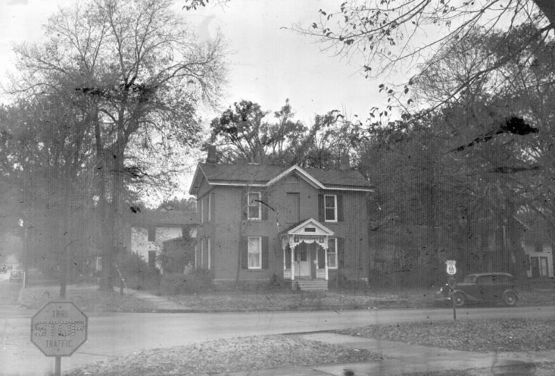 Victorian house. Road sign is for US 59 and K-10. Somewhere on 6th Street, Lawrence, Kansas, November 1947