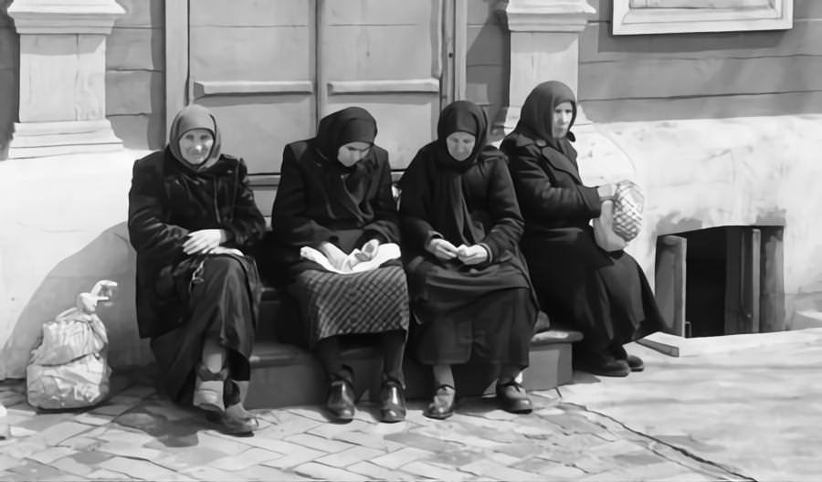 Female residents of the Soviet city of Kyiv, sitting together on the steps of a building in one of the city streets May 1960