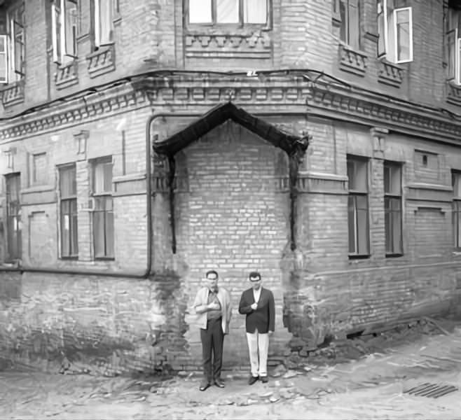 Young politicians with hand on their chests in front of house in Kyiv.