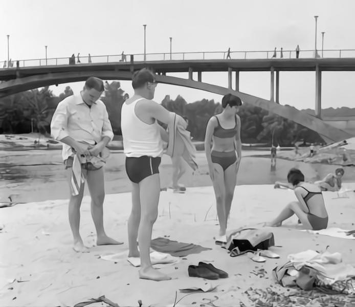 Men wearing bathing trunks and women bikinis at Dnieper River in Kyiv