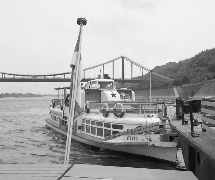 Steamer at a landing stage at Dnieper River in Kyiv. In the back a bridge.