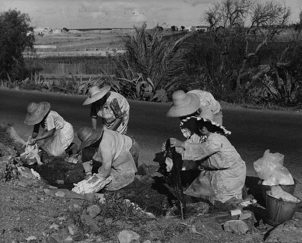 A group of peasant women doing washing in stream by road near Las Palmas, 1962