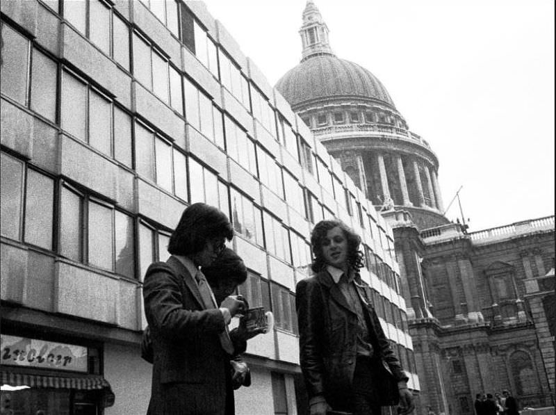 Wrestling with a tin of peanuts in the shadow of St Paul's Cathedral, Paternoster Square, London, April 1973