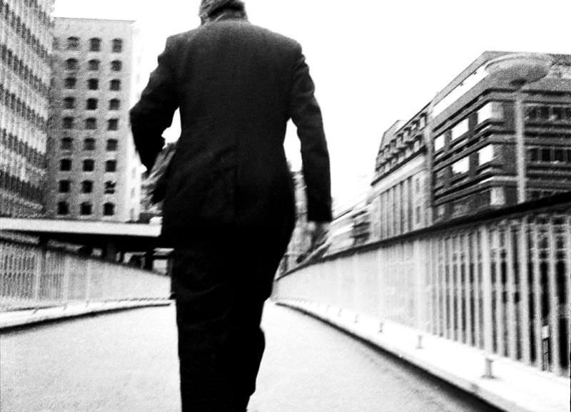 City messenger on the high walk from the Barbican to Wood Street, London, March 1974