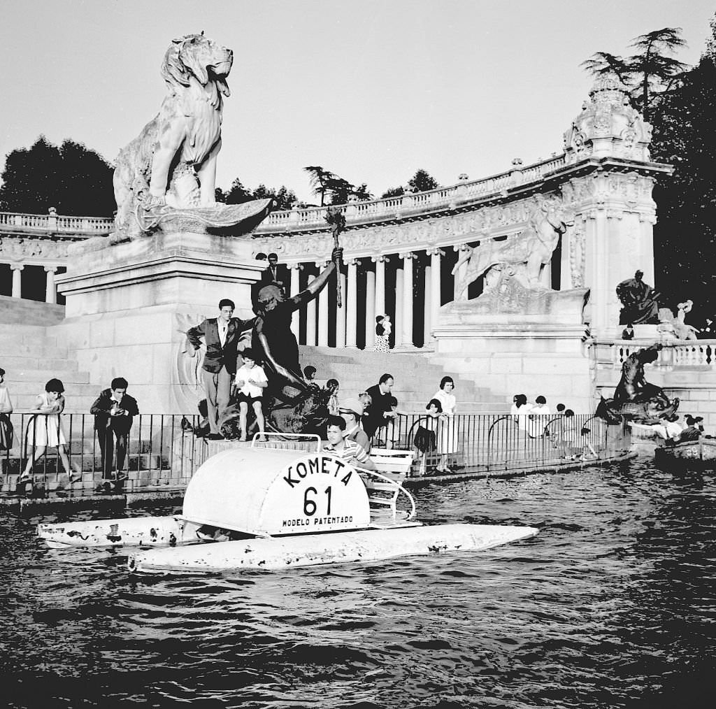A pedalo on a boating lake in front of the Monument to Alfonso XII in the Retiro approximately during the 1960s in Madrid, Spain.