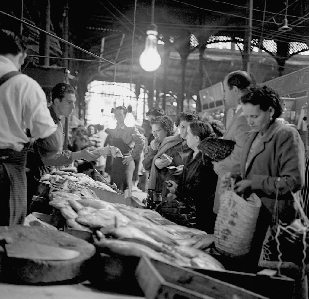 People shop at a fish market during the 1960s in Madrid, Spain.