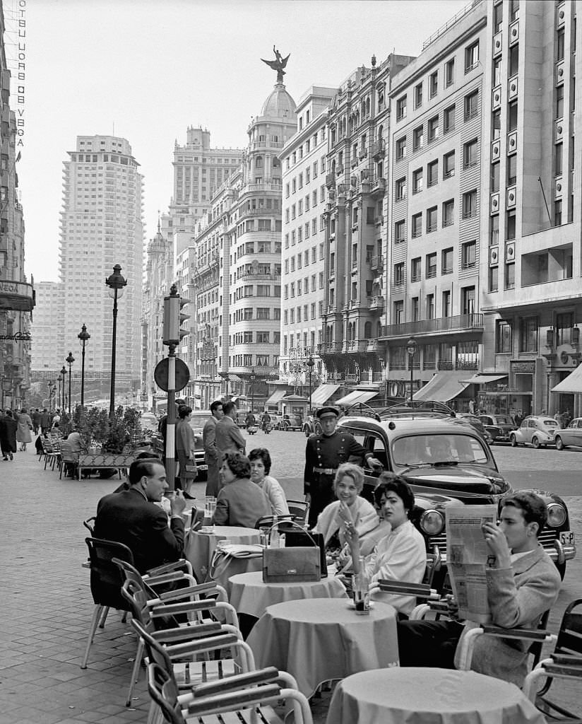 Several people on a terrace on the Gran Via during the 1960s in Madrid, Spain.