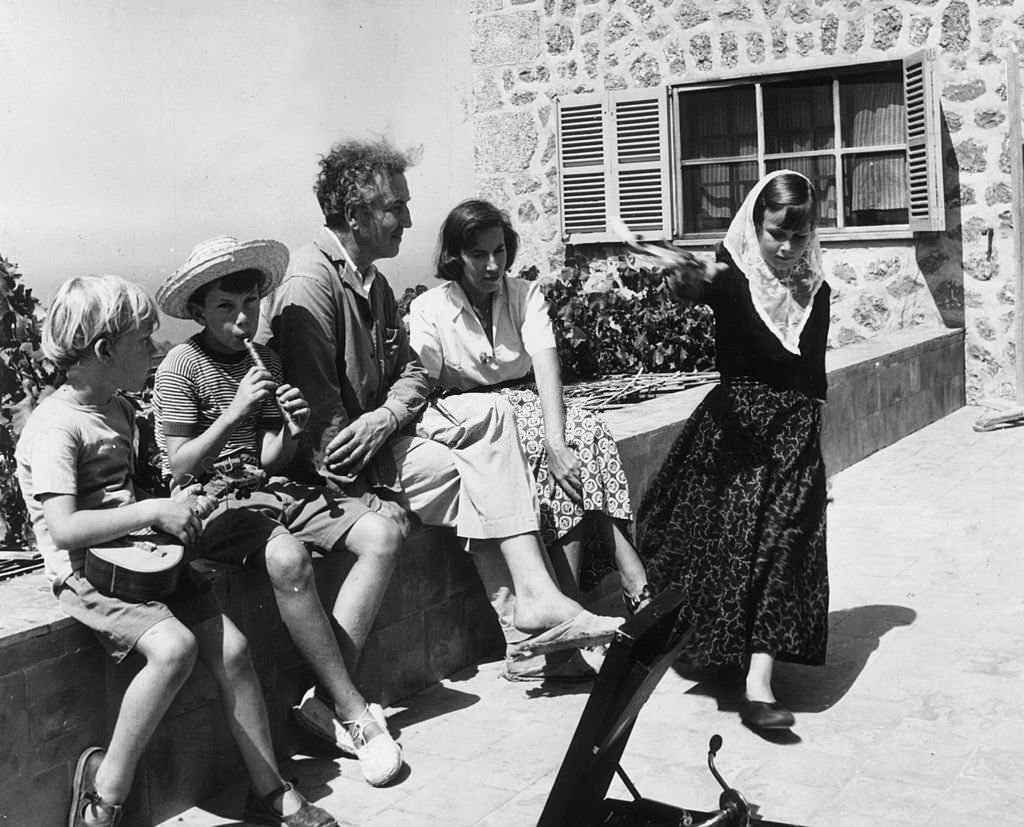 English poet, writer and classical scholar Robert Ranke Graves with his second wife Beryl and his children outside their holiday home in Deya, on the island of Majorca, 1954
