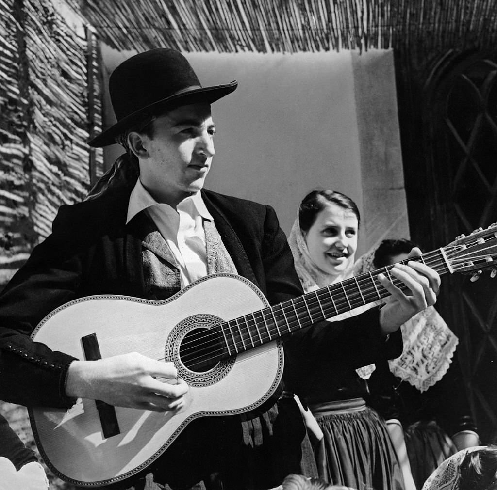 A Spanish guitarist and two young women in folk costumes from the Balearic island of Majorca, 1955.