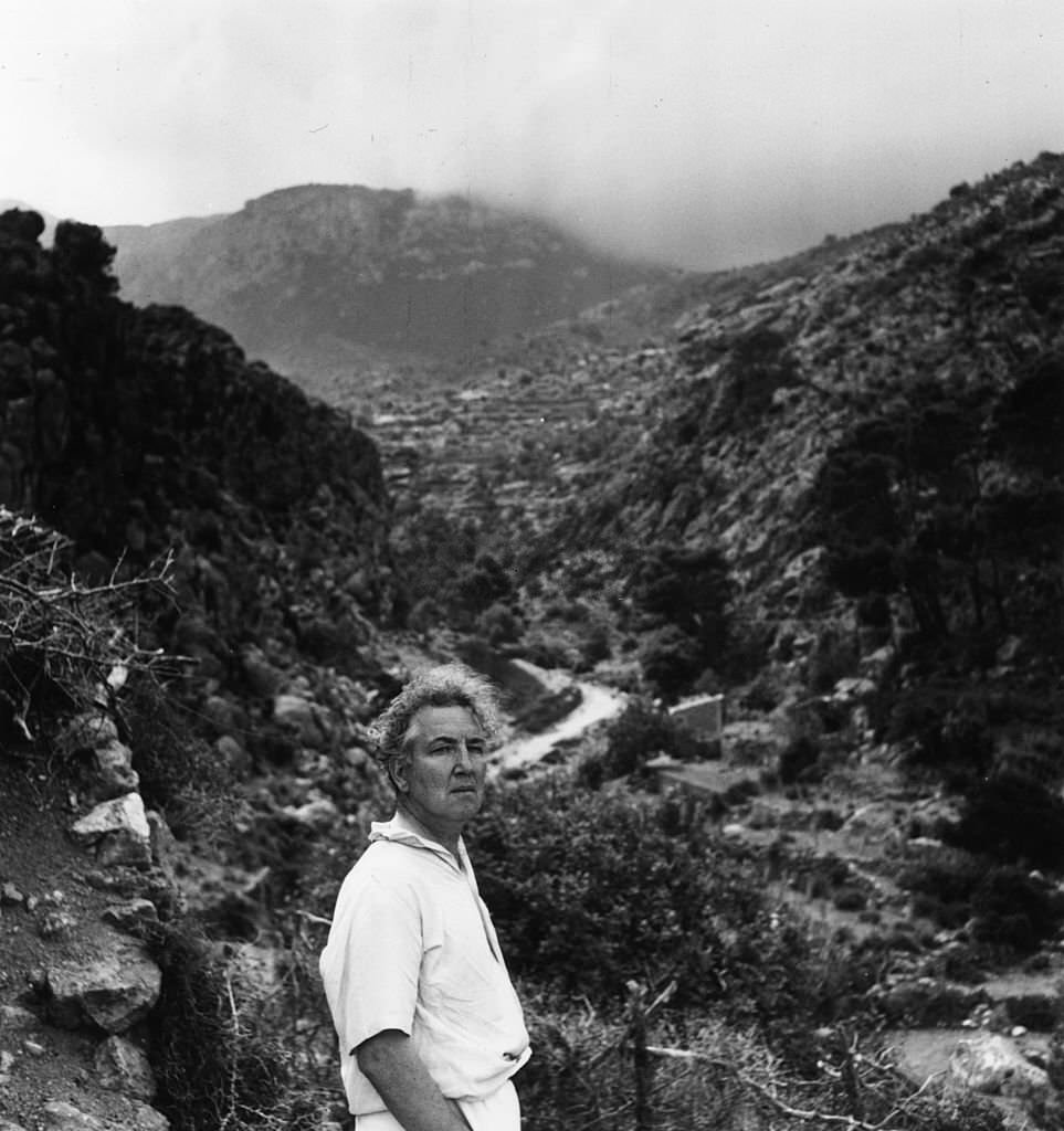 Robert Ranke Graves surveys the hilly landscape of his home island of Majorca, 1954